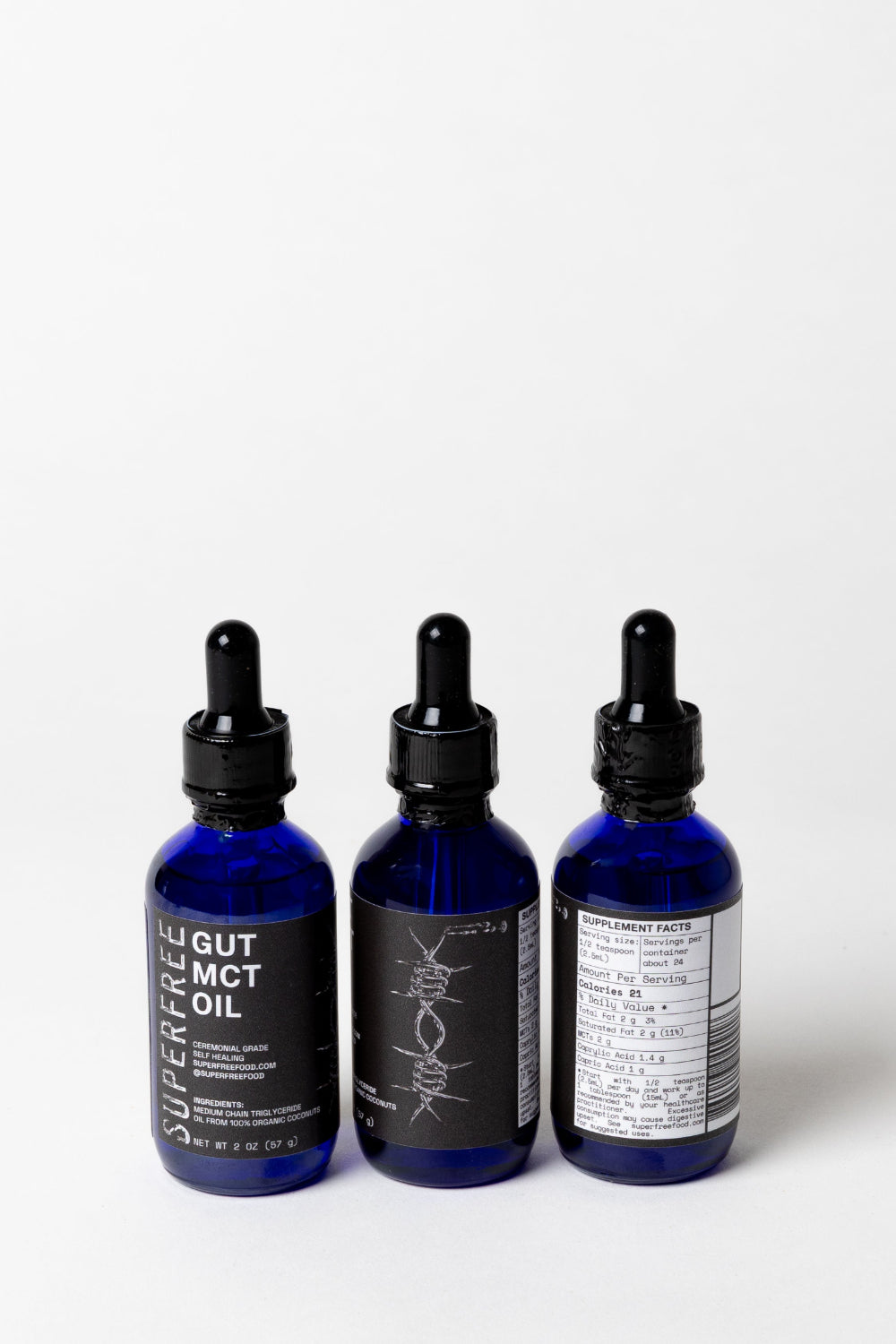 Three blue bottles with black caps on a white background