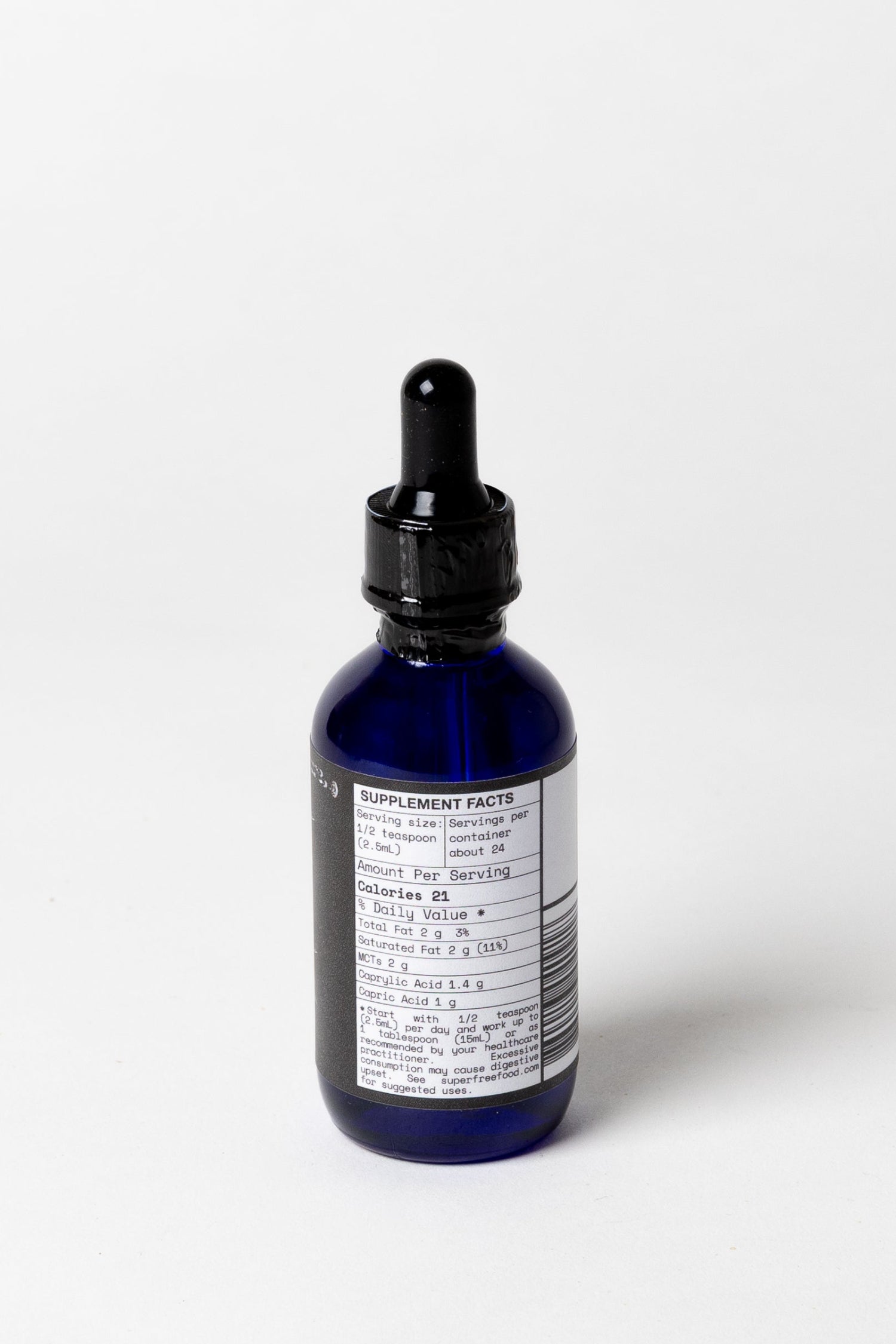 Blue glass dropper bottle with label on a white background